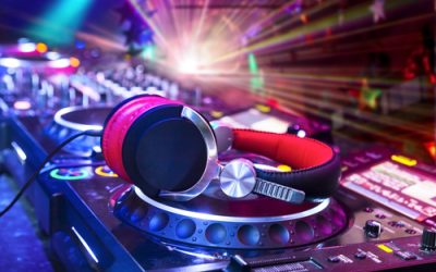 Dj,Mixer,With,Headphones,At,Nightclub.,In,The,Background,Laser